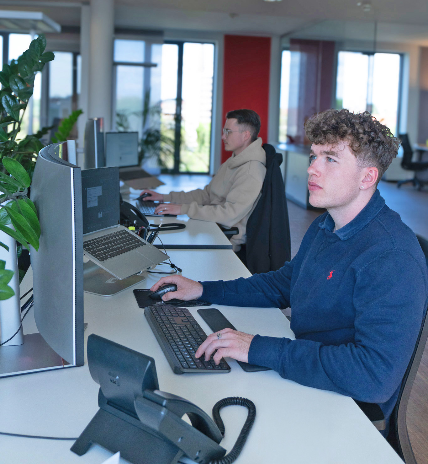 Welectron employees at their desks in the office